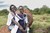 Two girls in Maasai traditional dress look into the camera and smile