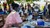  Mama Lamoro (pictured right) and her eight-month-old baby, Akello, attend a vaccination drive in Amuru District, Uganda, April 2021