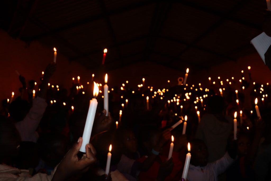 People hold candles at an Alternative Rites of Passage Ceremony in Kajiado, Kenya, 2024. (c) Amref Health Africa/Dennis Ochiel