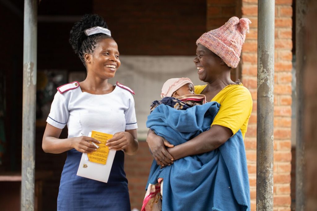 Rachel Mamboni-Nurse and Midwife Technician talking with Roseby Chipilala who has come for a clinic with her child at Mapelera Health Centre in Chikwawa.