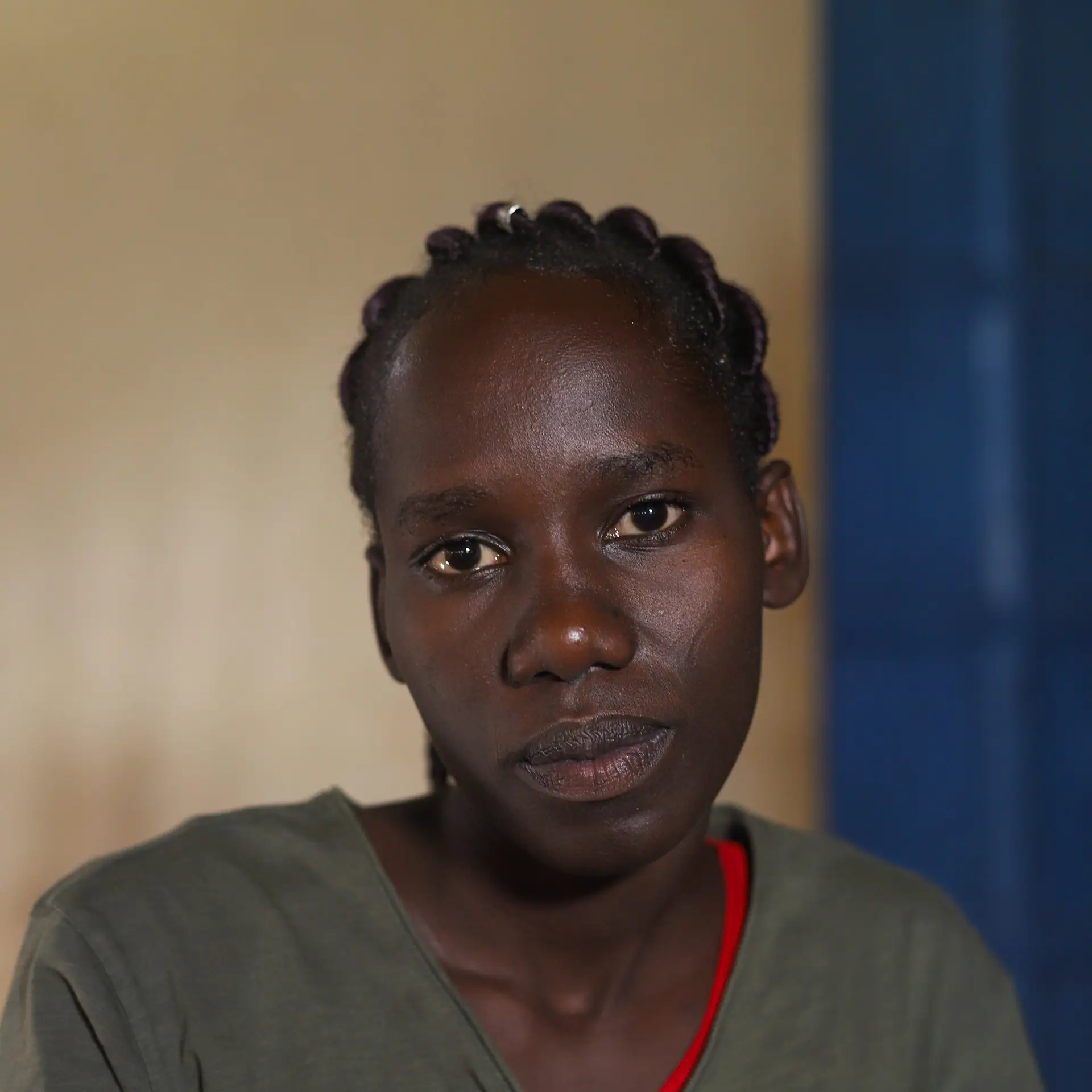 Jane looks into the camera. She is defiant and sad. It is a portrait of head and shoulders.