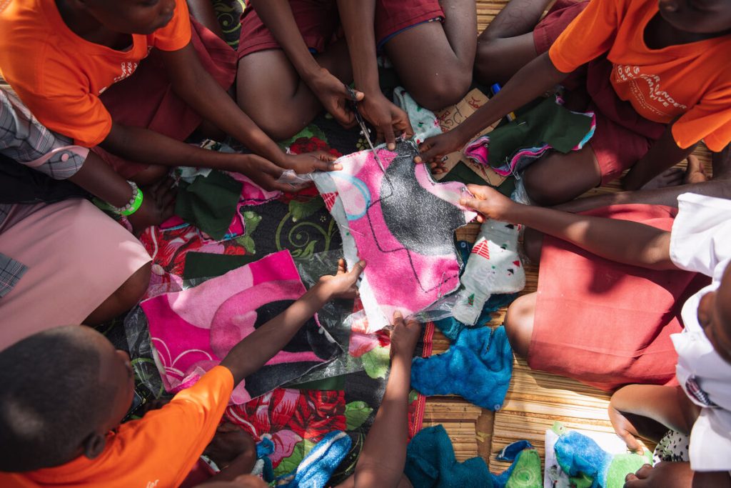 Children in the pad making group make reusable pads at the Bugana Primary School Bukana Village in Namayingo district.