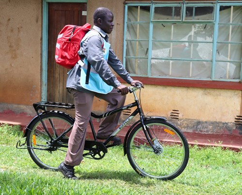 Patrick Wabuko, CHP Kenya, with his bike and medical backpack. (c) Amref Health Africa in Kenya